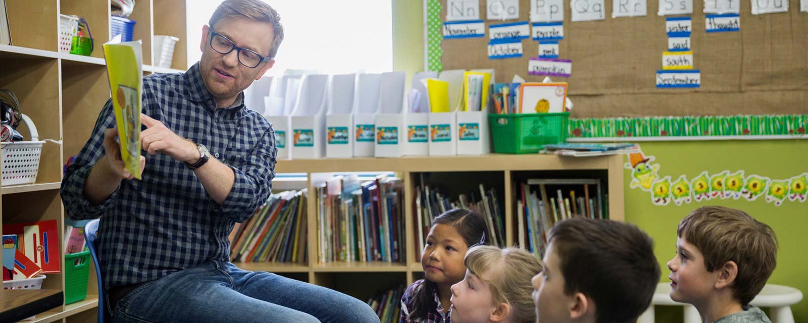 A Teacher reading to young students